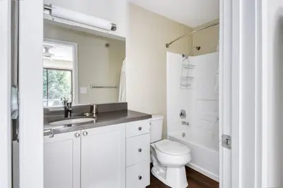 a white bathroom with a toilet and a sink at La Jolla 1br w gym wd pool nr bars shops SAN-8 in San Diego