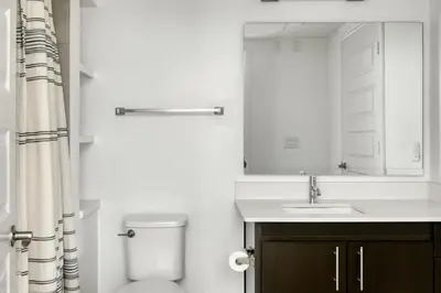 a bathroom with a toilet and a sink and a mirror at Mission Valley 1br w gym wd pool nr bars SAN-14 in San Diego