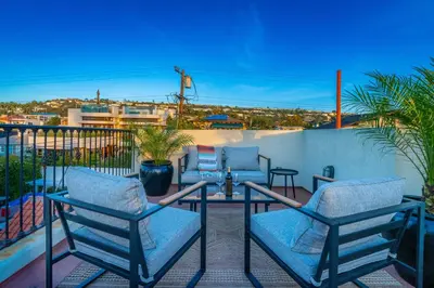 a patio with chairs and a table on a balcony at Ocean View Spanish Beauty Half Block to Beach in San Diego