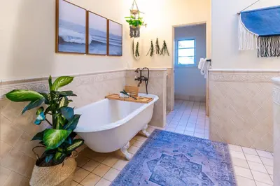 a bathroom with a tub and a potted plant at Ocean View Spanish Beauty Half Block to Beach in San Diego