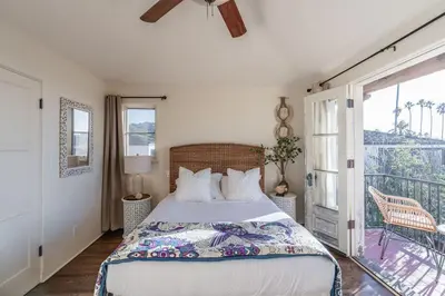 a bedroom with a bed and a balcony at Ocean View Spanish Beauty Half Block to Beach in San Diego