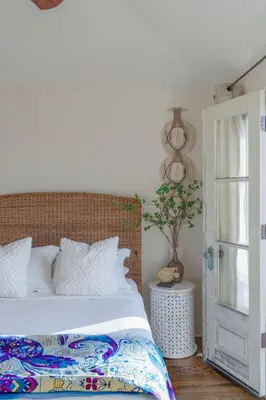 a bedroom with a bed and a door with a plant at Ocean View Spanish Beauty Half Block to Beach in San Diego