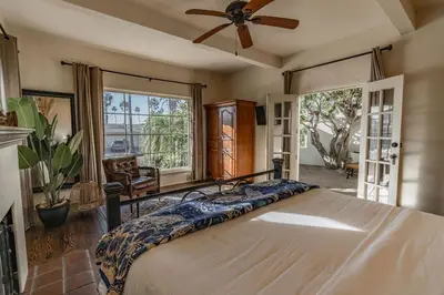 a bedroom with a bed and a ceiling fan at Ocean View Spanish Beauty Half Block to Beach in San Diego