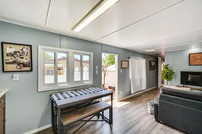 a living room with a table and a couch at Low-Key Poway Home about 20 Mi to La Jolla and San Diego in Poway