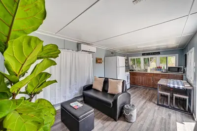 a living room with a chair and a refrigerator at Low-Key Poway Home about 20 Mi to La Jolla and San Diego in Poway