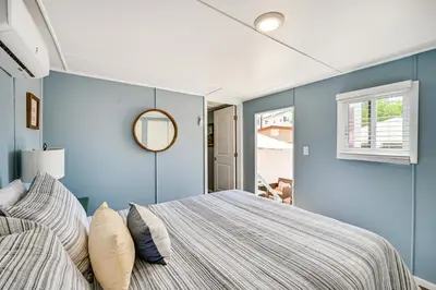 a bedroom with blue walls and a bed with pillows at Low-Key Poway Home about 20 Mi to La Jolla and San Diego in Poway