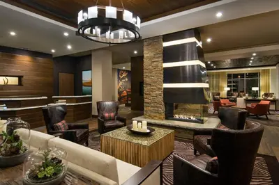 a lobby of a hotel with chairs and a fireplace at Courtyard by Marriott Irvine Spectrum in Irvine