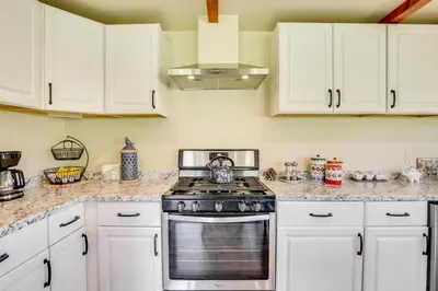 a kitchen with white cabinets and a stove top oven at Julian Cottage Stay with Near Wildlife and Wineries in Julian