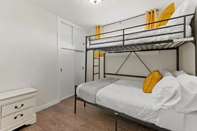a bedroom with two bunk beds and a desk at LOVELY Ocean View Beach House 3BR Sleeps 9 in San Diego