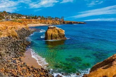 a beach with a large rock in the water at LOVELY Ocean View Beach House 3BR Sleeps 9 in San Diego