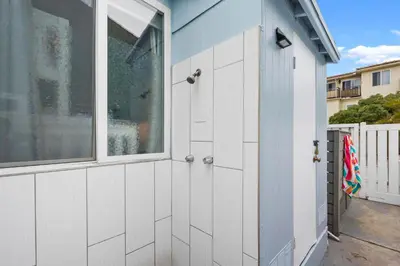a garage with white doors and a window at Beach-2-Bay 2br - Beach - AC - Patio in San Diego