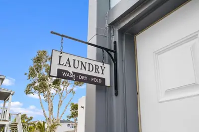a sign hanging on the side of a building at Beach-2-Bay 2br - Beach - AC - Patio in San Diego