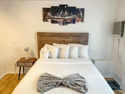 a bedroom with a bed with a bow tie on it at Charming 2nd Ave Lofts in Downtown San Diego with Parking in San Diego