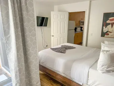 a bedroom with a white bed and a window at Charming 2nd Ave Lofts in Downtown San Diego with Parking in San Diego
