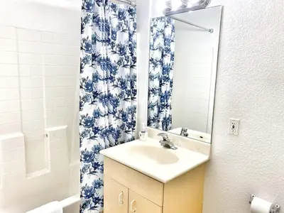 a bathroom with a sink and a mirror at Charming 2nd Ave Lofts in Downtown San Diego with Parking in San Diego