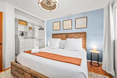 a bedroom with a large bed with a blue wall at South Park - Mountain Views - Central - Tranquil in San Diego