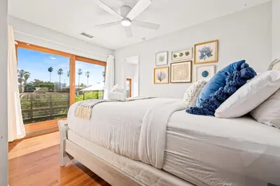 a white bedroom with a large bed and a window at South Park - Mountain Views - Central - Tranquil in San Diego