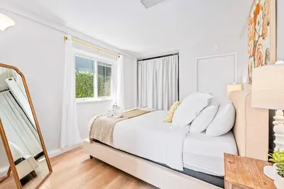 a white bedroom with a bed and a window at South Park - Mountain Views - Central - Tranquil in San Diego