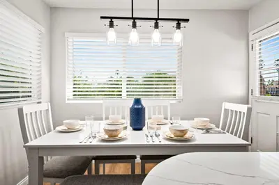 a white dining room with a white table and chairs at South Park - Mountain Views - Central - Tranquil in San Diego