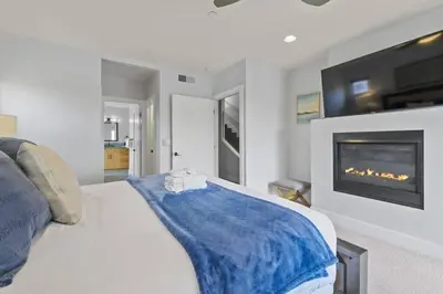 a bedroom with a bed with a tv and a fireplace at Pacific Beach Paradise by Cardo -Spacious Retreat in San Diego