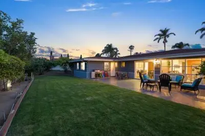 a house with a yard with chairs and a patio at 3 Living Rooms - Spacious - Family-Friendly in National City