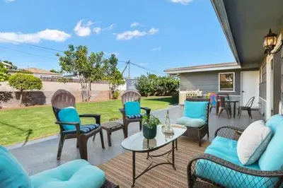 a patio with chairs and a table with a view at 3 Living Rooms - Spacious - Family-Friendly in National City