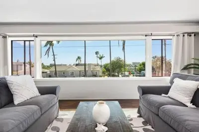 a living room with two couches and a large window at 3 Living Rooms - Spacious - Family-Friendly in National City