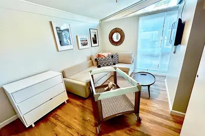 a living room with a couch and a table at NEW Beautiful San Diego Mid-Century Treehouse in Spring Valley