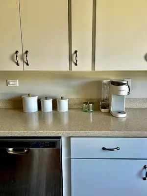 a kitchen counter with white cups and a coffee maker at NEW Beautiful San Diego Mid-Century Treehouse in Spring Valley