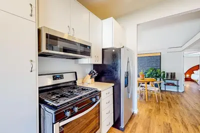 a kitchen with a stove and a refrigerator at NEW Beautiful San Diego Mid-Century Treehouse in Spring Valley
