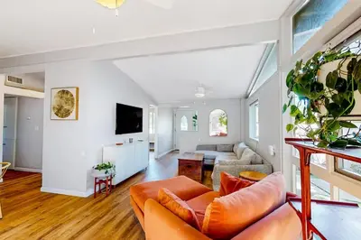 a living room with a couch and a tv at NEW Beautiful San Diego Mid-Century Treehouse in Spring Valley
