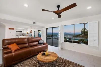 a living room with a brown leather couch and a table at Sun&Star Studded Central Luxury with Hottub, Pool, Views in Escondido