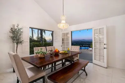 a dining room with a wooden table and chairs at Sun&Star Studded Central Luxury with Hottub, Pool, Views in Escondido