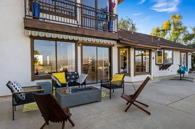 a house with a patio with chairs and a balcony at Sun&Star Studded Central Luxury with Hottub, Pool, Views in Escondido