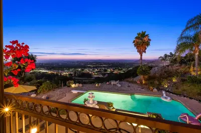a view of a pool from a balcony at night at Sun&Star Studded Central Luxury with Hottub, Pool, Views in Escondido