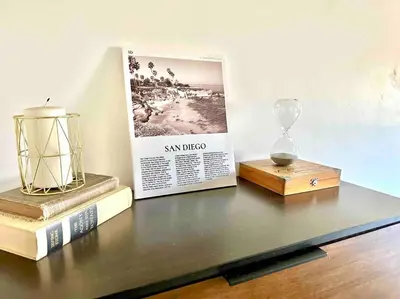 a table with books and a clock on top of it at Modern Home with View and Large Private backyard in San Diego