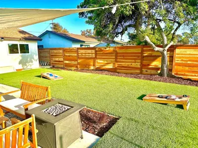 a backyard with a barbecue grill and a fence at Modern Home with View and Large Private backyard in San Diego