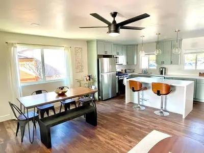 a kitchen with a table and chairs and a dining room at Modern Home with View and Large Private backyard in San Diego
