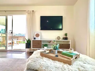 a living room with a flat screen tv on a wall at Modern Home with View and Large Private backyard in San Diego