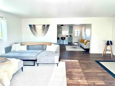 a living room with a couch and a table at Modern Home with View and Large Private backyard in San Diego