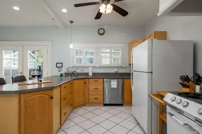 a kitchen with white appliances and a ceiling fan at South Park Charmer - Close to Zoo - Backyard Oasis in San Diego