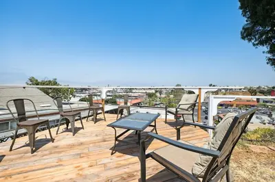 a row of chairs and a table on a deck at Family Retreat by Cardo - Sleeps 10 in National City
