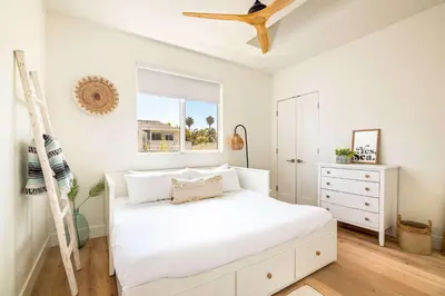 a white bedroom with a bed and a window at Contemporary Indoor Outdoor Living Walk to Beach in Encinitas