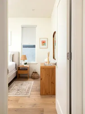 a bedroom with a bed and a table with a mirror at Contemporary Indoor Outdoor Living Walk to Beach in Encinitas