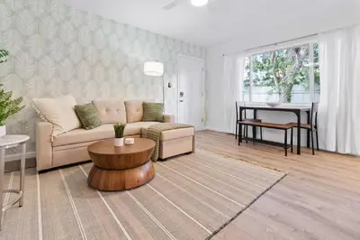 a living room with a couch and a table at Pacific Beach Charm Beach and Shops Steps Away in San Diego
