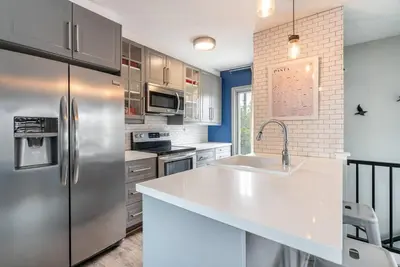 a kitchen with a stainless steel refrigerator and a sink at PORCHLIGHT HOME Central San Diego FREE parking in San Diego