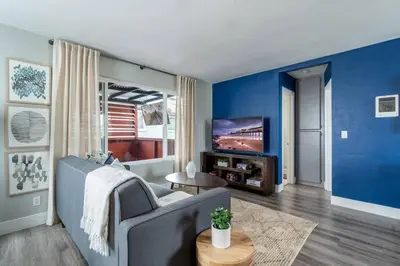 a living room with a couch and a tv at PORCHLIGHT HOME Central San Diego FREE parking in San Diego