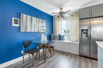 a kitchen with a table and a blue wall at PORCHLIGHT HOME Central San Diego FREE parking in San Diego