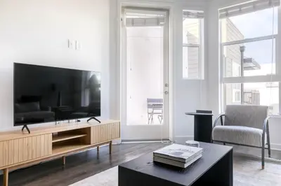 a living room with a large television and a table at Mission Valley 1br w gym wd pool nr bars SAN-18 in San Diego