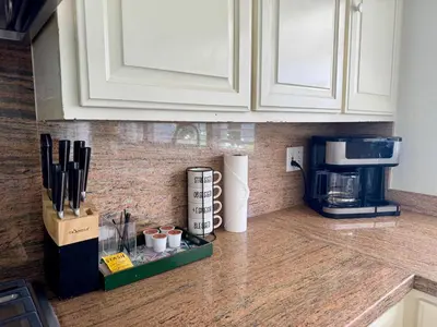 a kitchen counter with a coffeemaker and a coffee maker at Ocean Breeze Haven Sunset & Pool La Jolla in San Diego